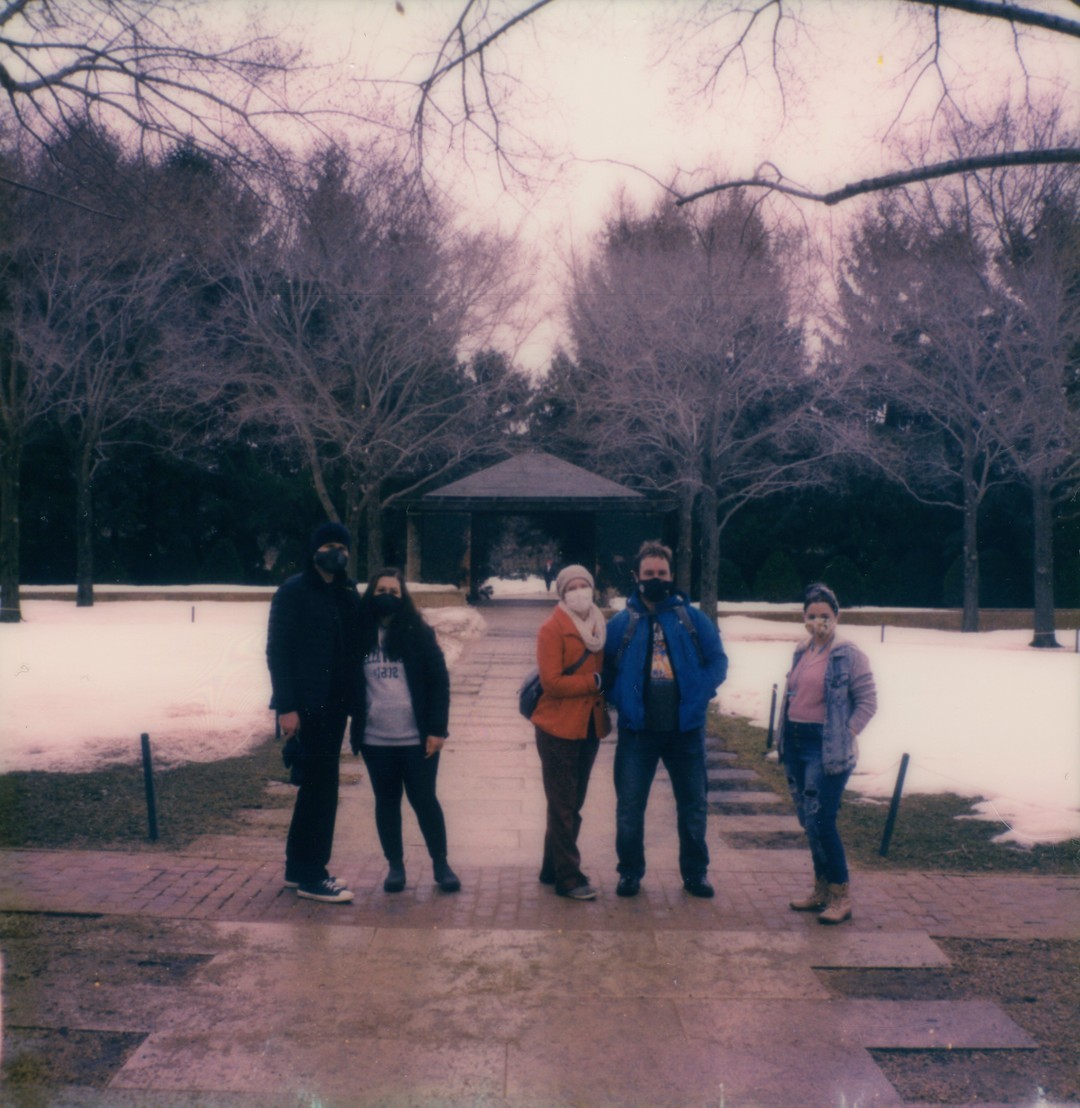 A group of five people spread out on a path in the Chicago Botanic Gardens
